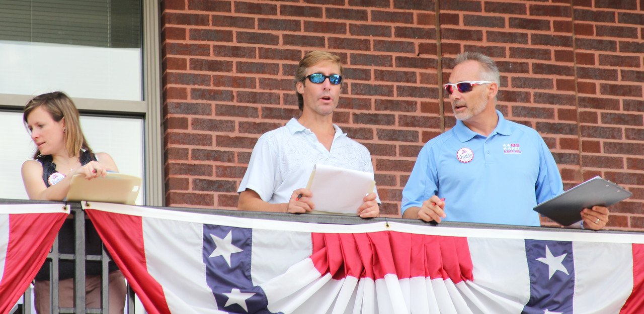Bret Strong, shareholder of The Strong Firm PC (shown right), Josh Urban, CEO of Memorial Hermann The Woodlands (shown center), and Jessica Fraser, CEO of Woodlands Online (shown left) serve as judges together at the South Montgomery County 4th of July Parade held on Saturday, July 4th, 2015