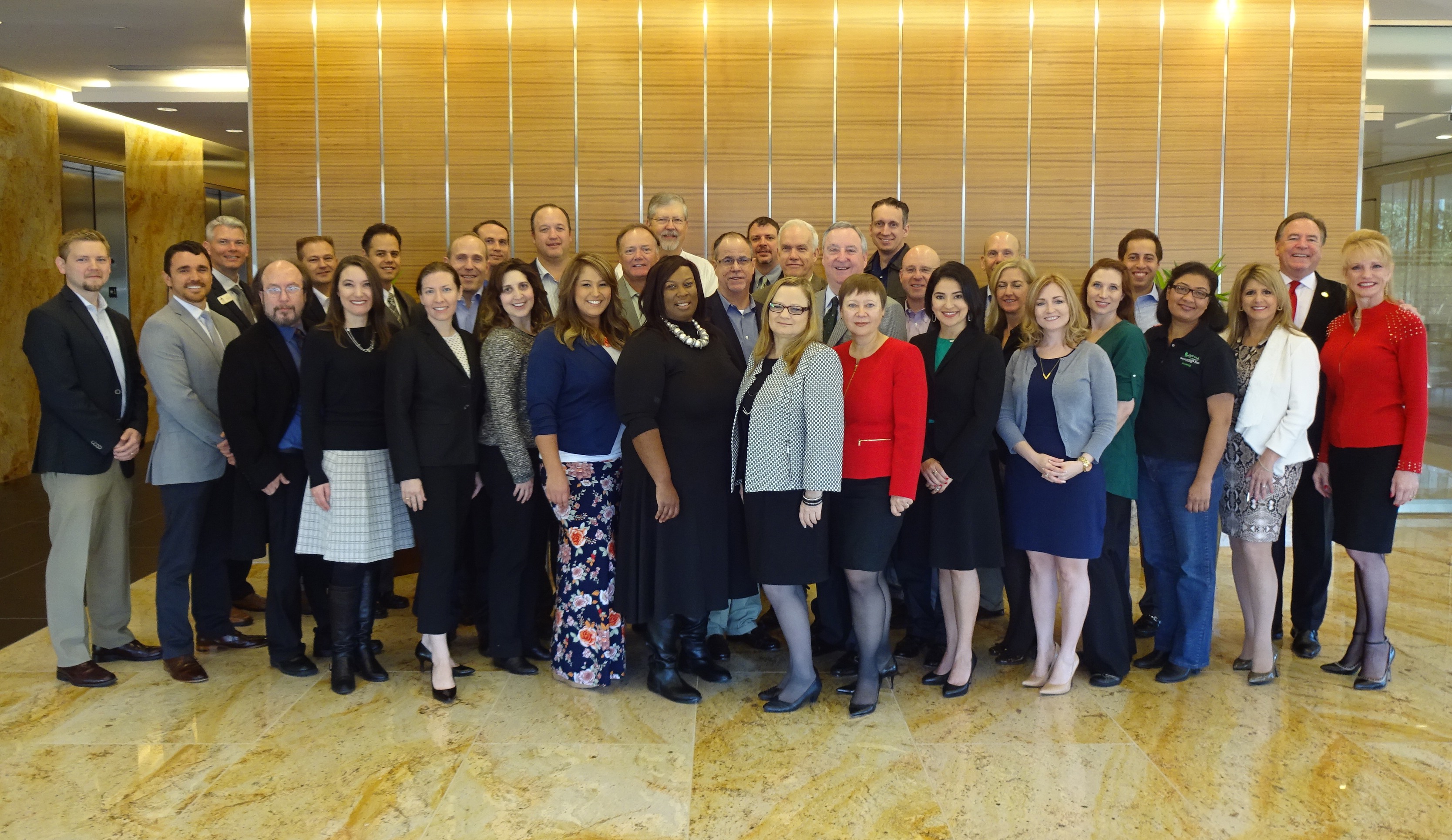 Wendy Lambie (shown fourth from the right) is shown with other members of the 2016 Economic Outlook Committee at a team meeting.