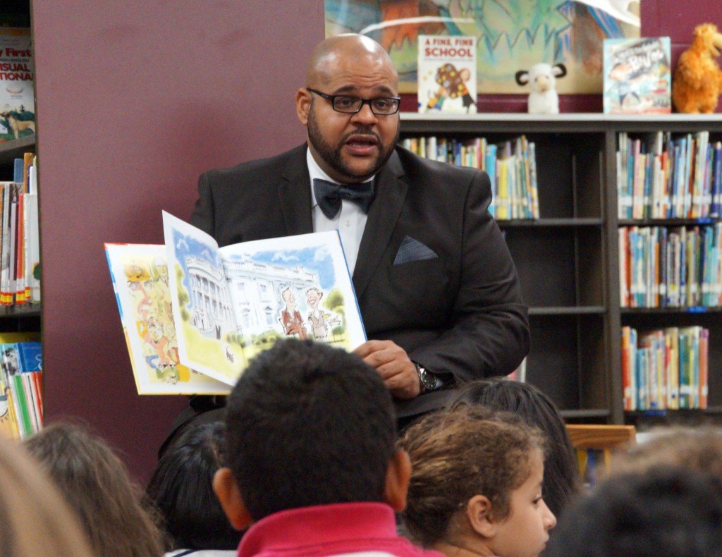 Eric Thiergood of The Strong Firm PC reads to the 4th grade class at Roth Elementary during story time.